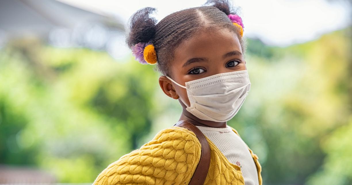 Child outside wearing a facemask